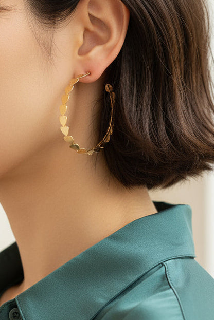 Close-up of a beautiful woman wearing gold hoop earrings with a blurred beautiful home
 background

